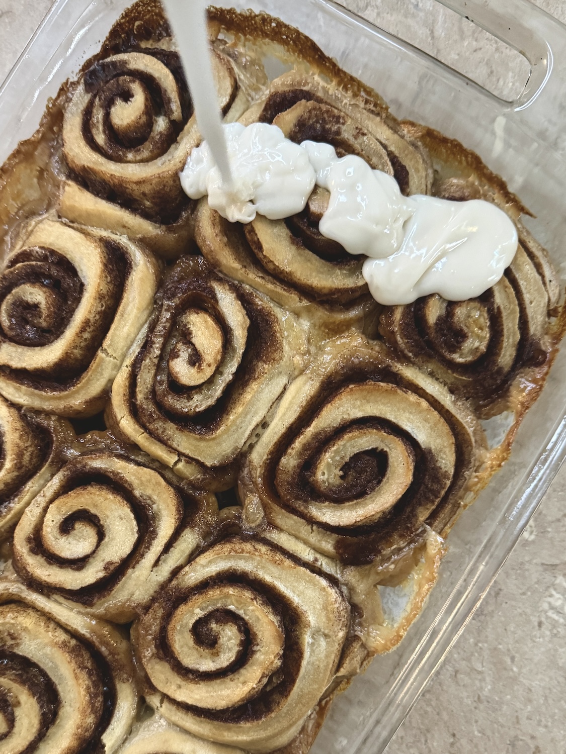 Icing fresh backed cinnamon rolls