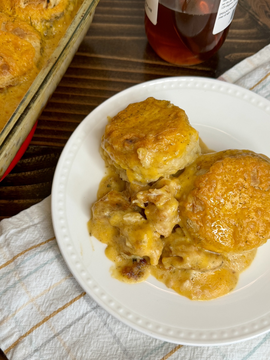 Freshly baked chicken and biscuits on a plate.