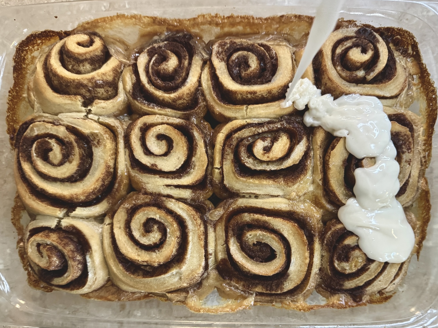 Icing fresh backed cinnamon rolls