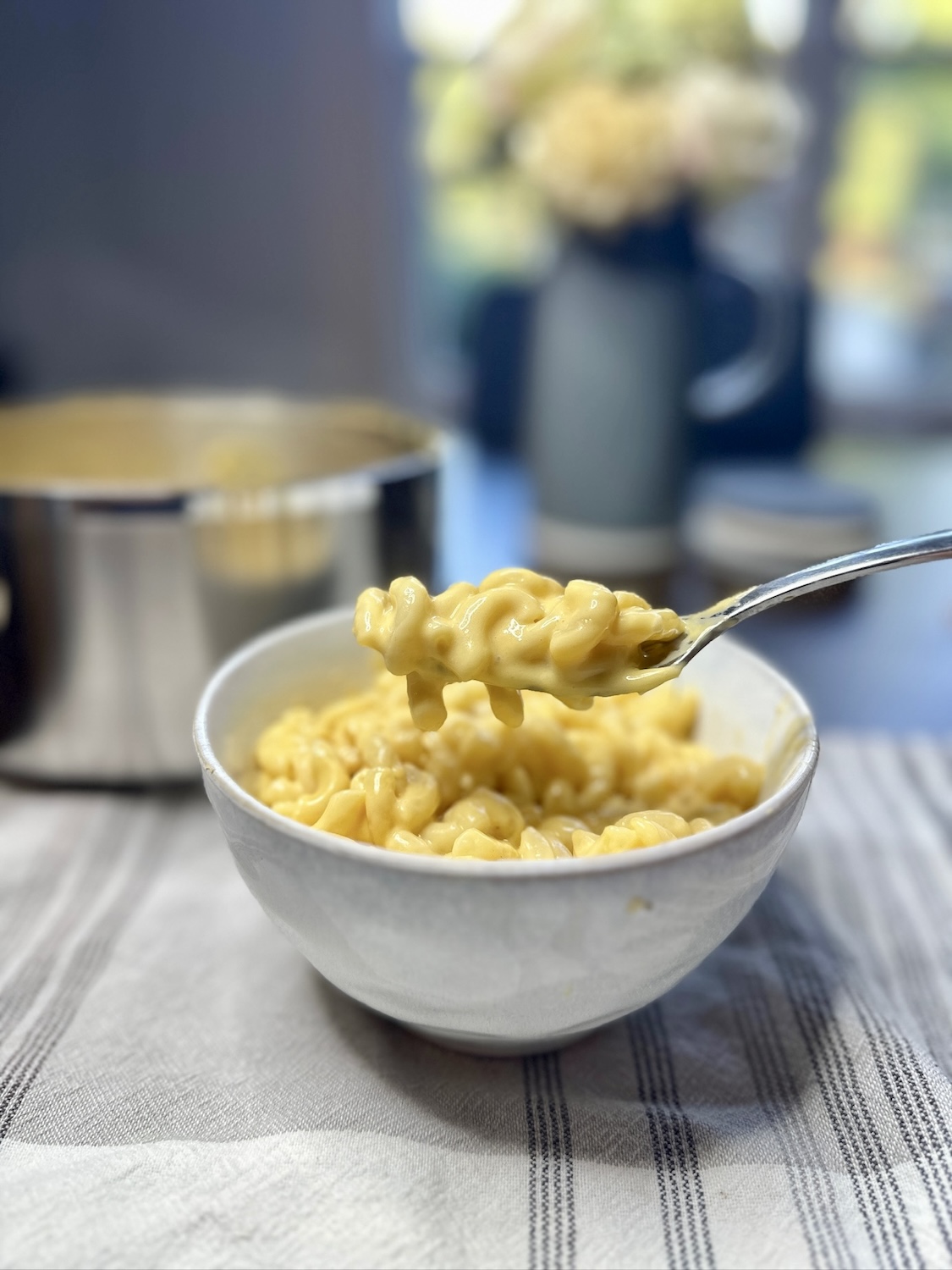 portrait photo of mac and cheese in a bowl