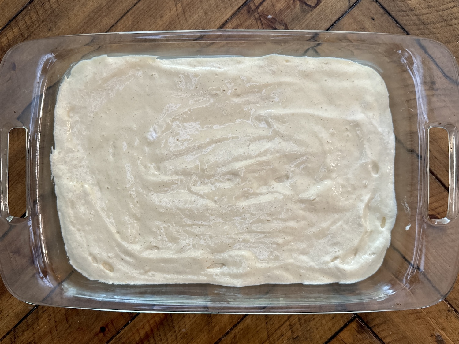 Tres Leches cake batter in a baking dish