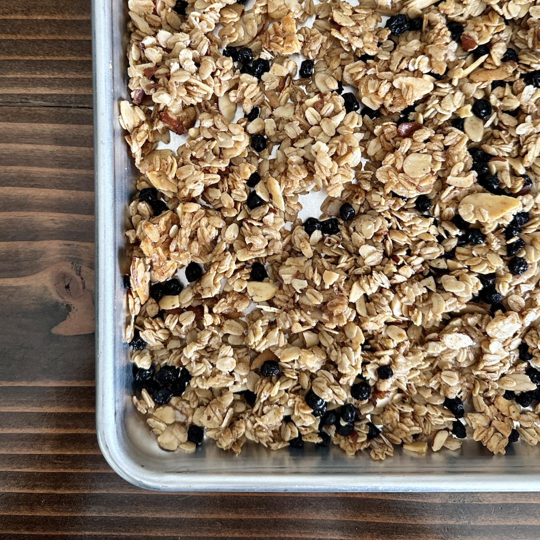 Blueberry muffin granola on a baking sheet