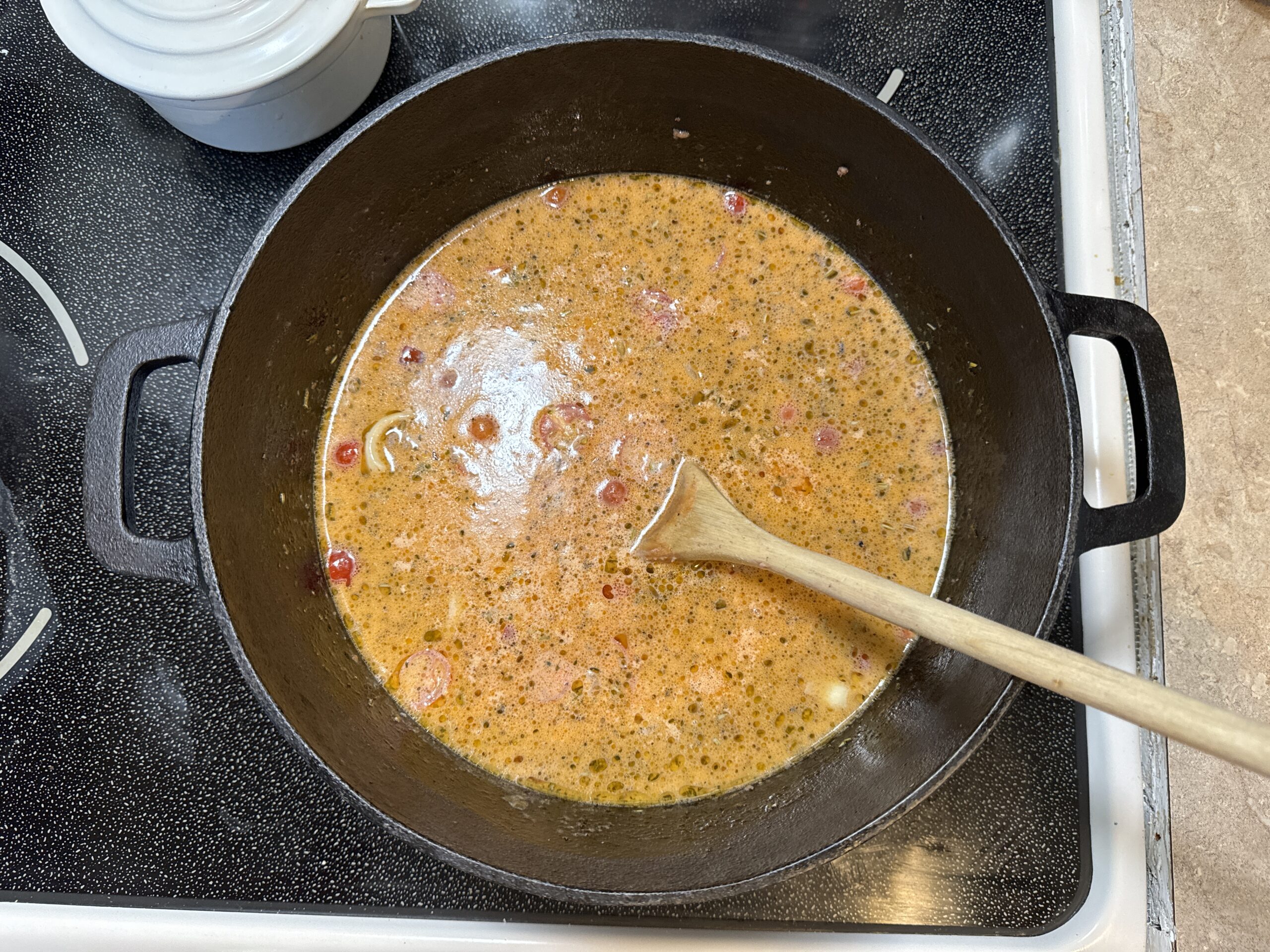 Ingredients added to dutch oven for one post creamy tomato pasta